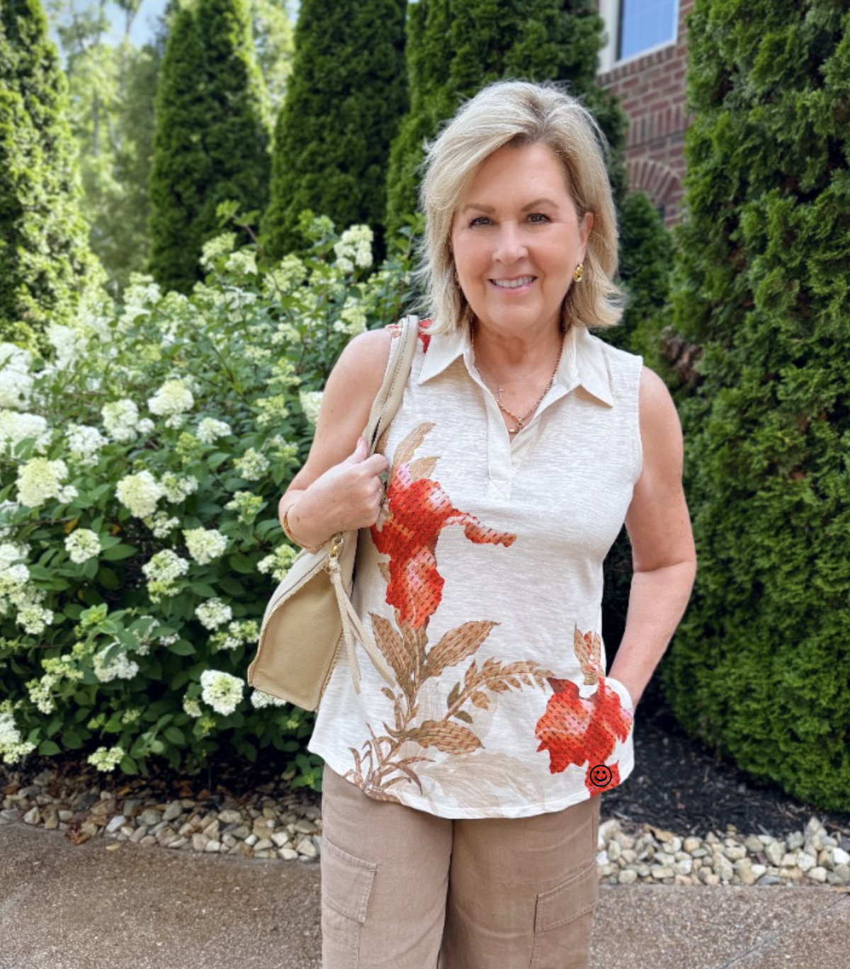 Tania wearing a sleeveless floral  top from Chico's